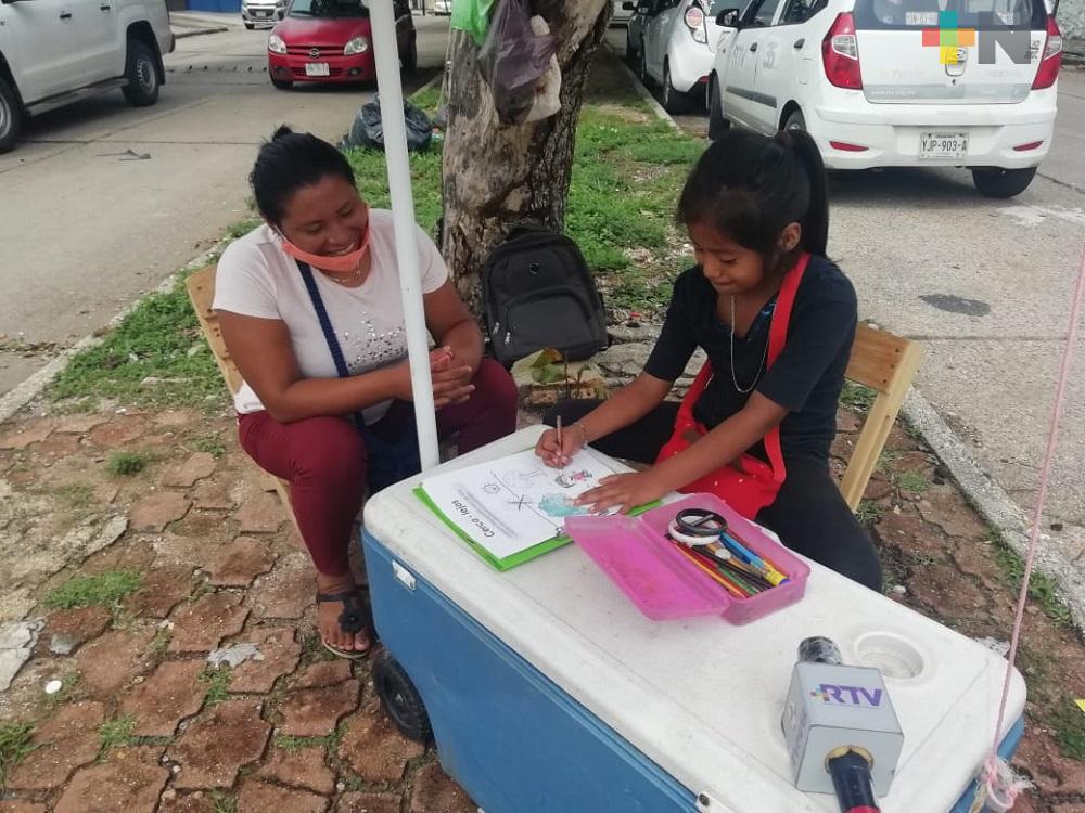 Mientras su mamá vende jugos, menor de edad no quiere dejar de aprender