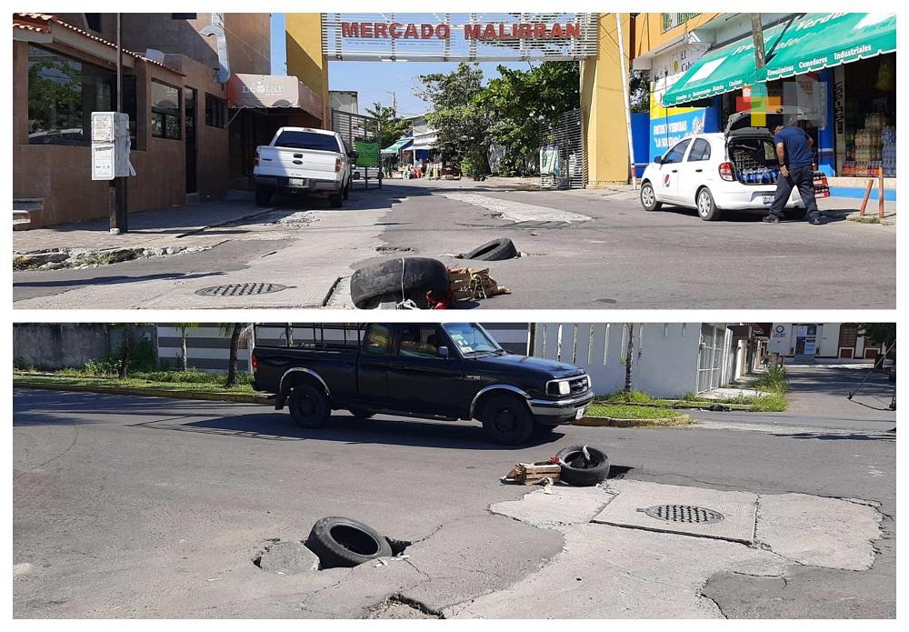 Con llantas cubren baches en accesos del mercado Malibrán